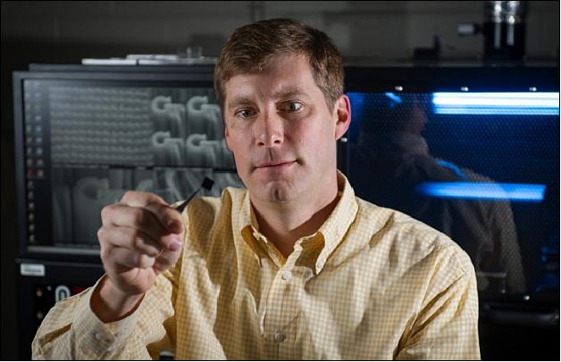 Figure 6: Jud Ready, a principal research engineer at GTRI, holds a chip containing bundles of carbon nanotubes grown in pits (image credit: Georgia Tech)