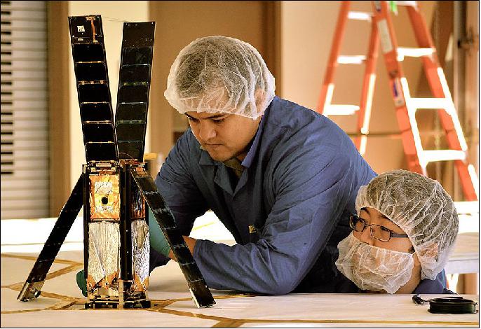 Figure 7: LightSail team members Alex Diaz (left) and Riki Munakata prepare the spacecraft for a sail deployment test (image credit: The Planetary Society) 12)