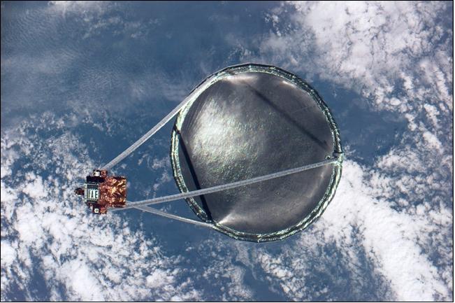 Figure 6: Photo from Shuttle of the Spartan-207/IAE freeflyer with the deployed antenna system (image credit: NASA)