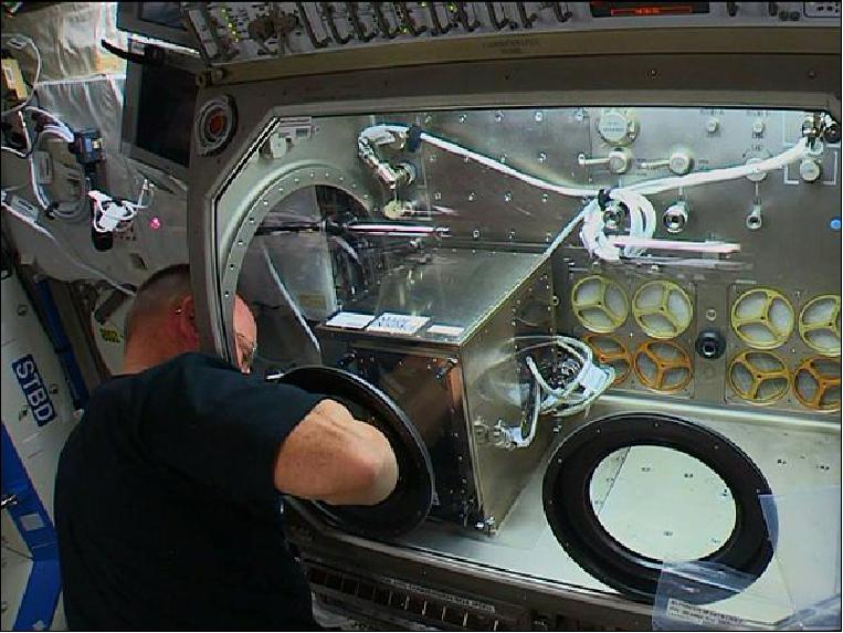 Figure 9: NASA astronaut Butch Wilmore installs the 3D Printer in the Microgravity Science Glovebox on the International Space Station (image credit: NASA TV)
