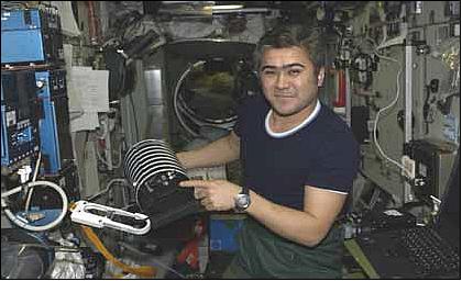 Figure 5: Photo of Salizhan Sharipov with the TNS-0 nanosatellite prior to deployment from ISS (image credit: RSIDE)