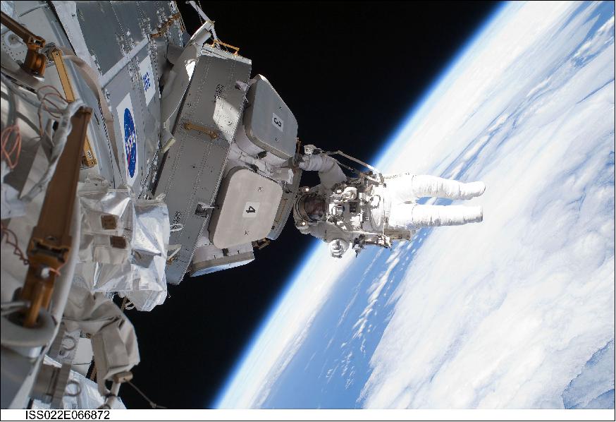 Figure 17: Astronaut Nicholas Patrick hanging on to Cupola after insulation has been removed (image credit: NASA)