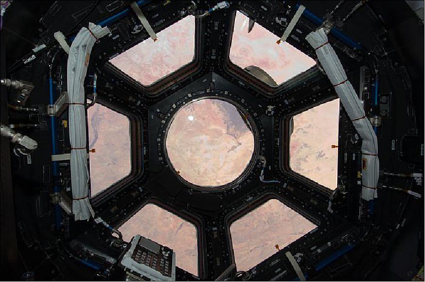 Figure 16: The seven-windowed Cupola, a 'bay window' on the International Space Station; the Sahara Desert is visible through the array of windows (image credit: NASA, ESA, JAXA)