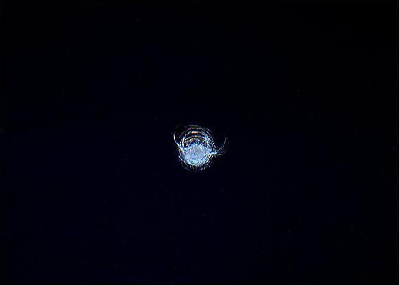 Figure 5: Photo of an impact chip at a Cupola window due to space debris (image credit: ESA, NASA)