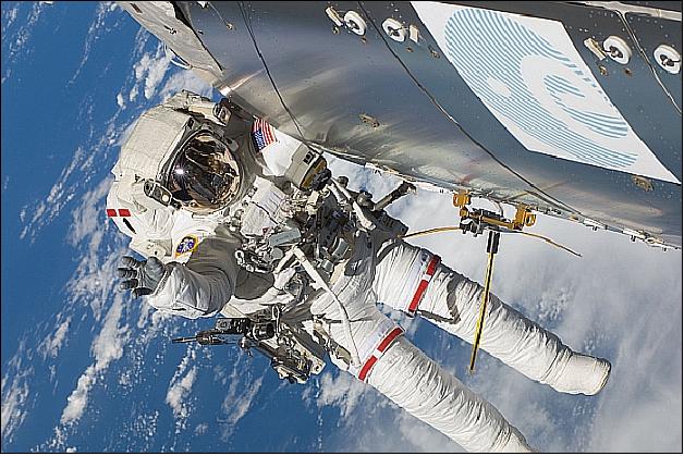 Figure 2: Astronaut Randolph Bresnik seen during Atlantis EVA-2 on 21 November 2009 with the unfurled AIS antenna, attached to Columbus to be used for experimental tracking of VHF signals of ships at sea (image credit: ESA, NASA)
