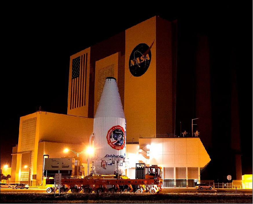 Figure 2: The Cygnus spacecraft for the upcoming Orbital ATK Commercial Resupply Services-6 mission is encapsulated inside its payload fairing as it moves past the Vehicle Assembly Building at NASA's Kennedy Space Center in Florida. It is being moved to Space Launch Complex-41 at Cape Canaveral Air Force Station image credit: NASA, Dimitrios Gerondidakis, Ref. 5)