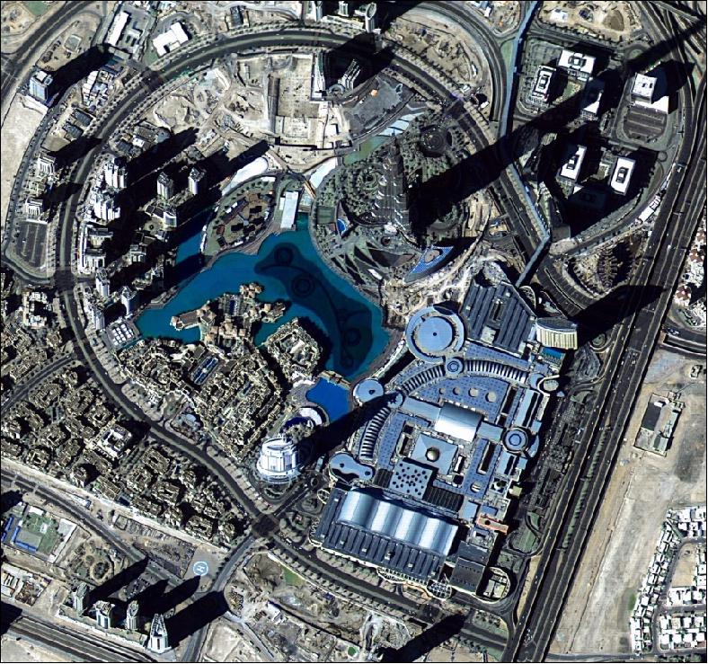 Figure 17: DubaiSat-2 image of Downtown Dubai with the Burj Khalifa (upper half center with the longest shadow to the north-east corner), the Burj Khalifa is the tallest building in the world with 828 m and more than 160 stories. The 1 m resolution image was acquired just before National Day on December 1, 2013 (image credit: MBRSC, former EIAST)