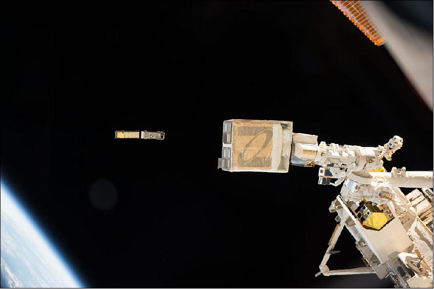 Figure 1: In this photo taken by NASA astronaut Peggy Whitson from inside the International Space Station cupola, the NanoRacks deployer (foreground) is clearly visible as the CXBN-2 and IceCube CubeSats deploy (image credit: NASA)