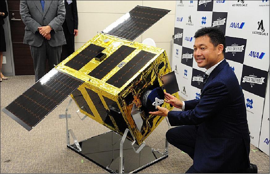 Figure 4: Astroscale founder and CEO Mitsunobu Okada uses a model of the company's new debris-retrieval satellite to explain how the device would collect space trash, in Tokyo's Chiyoda Ward on July 14, 2017 (image credit: Mainichi) 5)