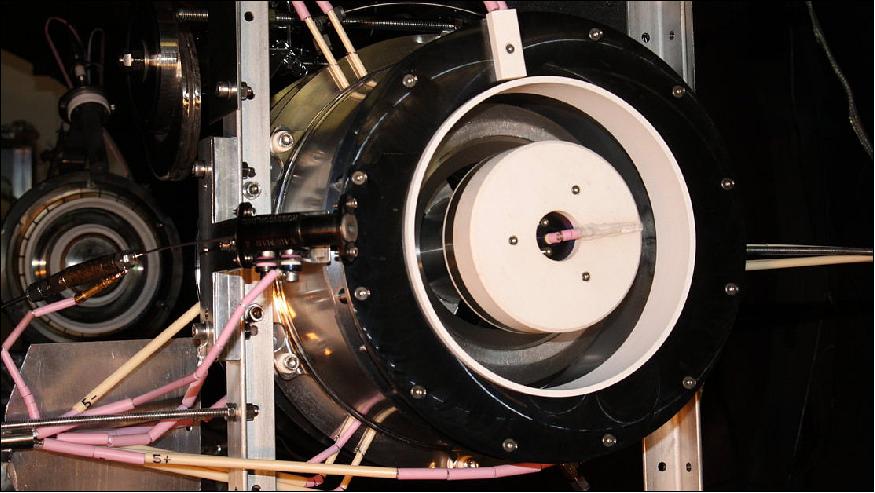 Figure 5: Thruster inside vacuum chamber: The air-breathing electric propulsion test set-up inside its vacuum chamber at Sitael in Italy. The Hall Effect Thruster can be seen in the foreground, and behind it the particle flow generator used to generate a simulated flow of orbital-velocity air (image credit: ESA)