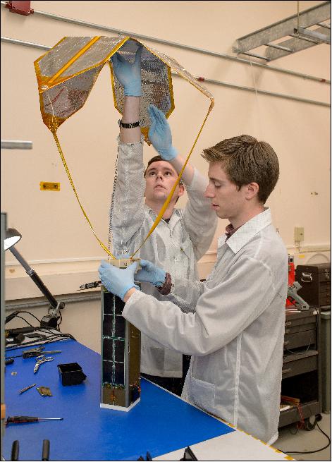 Figure 4: Engineers pack the TechEdSat-5 nanosatellite with the Exo-Brake payload. At almost 0.35m2, the Exo-Brake is made of Mylar and is controlled by a hybrid system of mechanic struts and flexible cord (image credit: NASA Ames, Dominic Hart)