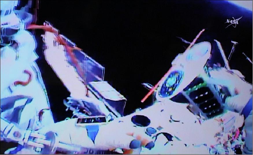 Figure 4: Fyodor Yurchikhin holding the Tomsk-TPU-120 nanosatellite on the outside of the ISS. The photo was shot from the GoPro camera attached to the cosmonaut's space suit. NASA also recorded the deployment of the satellite (image credit: Roscosmos, NASA)