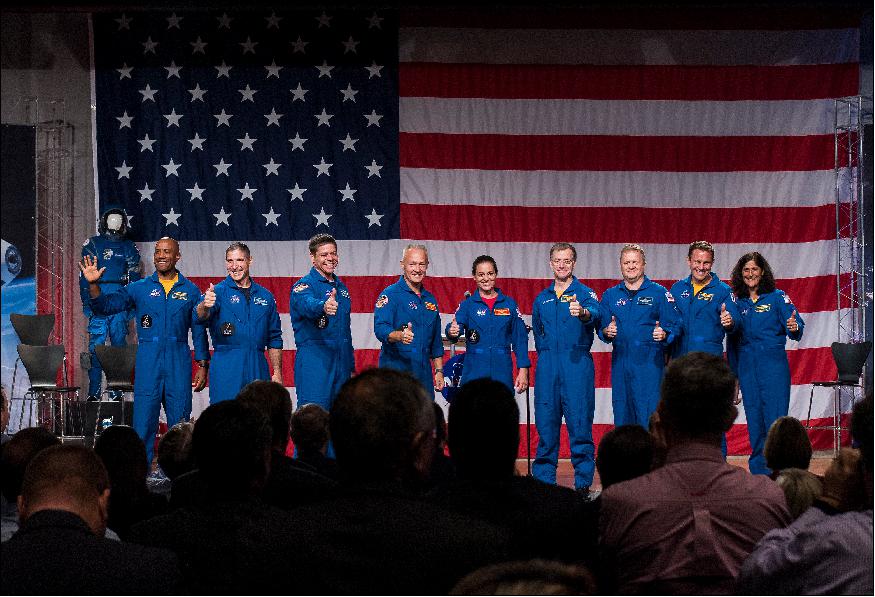 Figure 1: The first U.S. astronauts who will fly on American-made, commercial spacecraft to and from the International Space Station, wave after being announced, Friday, Aug. 3, 2018 at NASA's Johnson Space Center in Houston, Texas. The astronauts are, from left to right: Victor Glover, Mike Hopkins, Bob Behnken, Doug Hurley, Nicole Aunapu Mann, Chris Ferguson, Eric Boe, Josh Cassada, and Suni Williams. The agency assigned the nine astronauts to crew the first flight tests and missions of the Boeing CST-100 Starliner and SpaceX Crew Dragon (image credit: NASA/Bill Ingalls)
