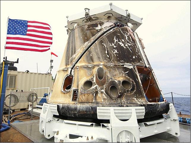 Figure 7: Photo of the Dragon spacecraft on the barge after being retrieved from the Pacific Ocean after splashdown on May 31, 2012 (image credit: SpaceX)