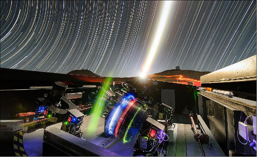 Figure 6: This night time long-exposure view shows the NGST telescopes during testing. The very brilliant Moon appears in the center of the picture and the VISTA (right) and VLT (left) domes can also be seen on the horizon (image credit: ESO, G. Lambert)