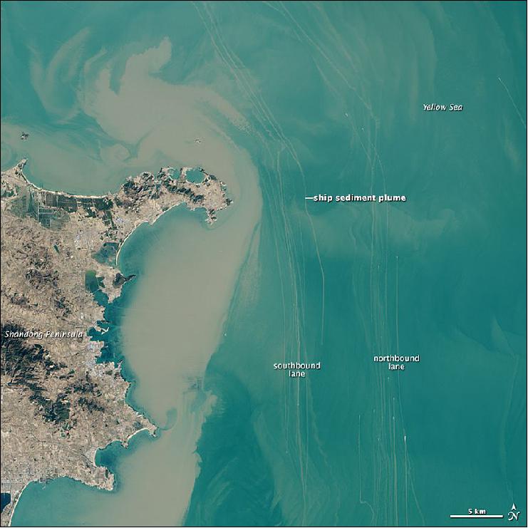 Figure 93: OLI on Landsat-8 captured this view of northbound and southbound shipping lanes off the coast of China's Shandong Peninsula on February 24, 2015. The lanes form one of the main routes from the Yellow Sea into the Bohai Sea and the Chinese ports of Dalian and Tianjin, two of the busiest in the world. As shown by this map, several lanes of traffic intersect northeast of the Shandong Peninsula (image credit: USGS, NASA Earth Observatory, Jesse Allen)