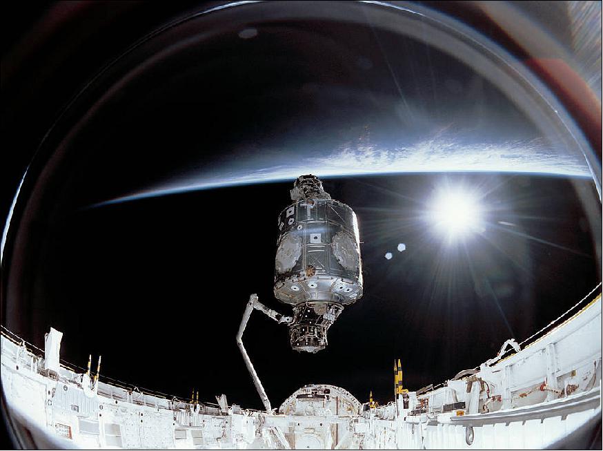 Figure 93: On Dec. 6, 1998, the crew of space shuttle mission STS-88 began construction of the International Space Station in Endeavour's payload bay, attaching the U.S.-built Unity node and the Russian-built Zarya module together in orbit. The crew carried a large-format IMAX® camera, used to take this image of Unity lifted out of Endeavour's payload bay to position it upright for connection to Zarya. The image shows the Unity module lifted up from the space shuttle by Canadarm to be joined to the Zarya module (image credit: NASA)