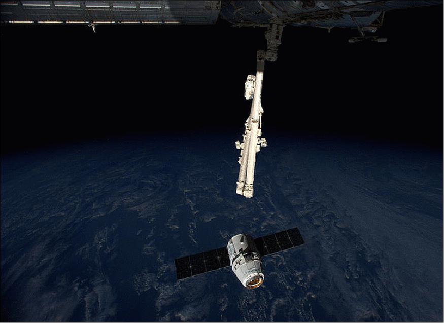 Figure 49: Photo of the approaching Dragon-4 capsule at the ISS; astronauts Alexander and Reid are using the Station's 17 m-long Canadarm2 robotic arm to capture and berth the fourth Dragon supply vessel (image credit: NASA TV)