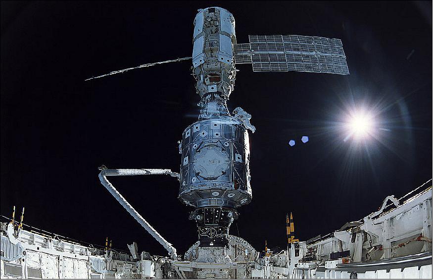 Figure 91: On December 7, 1998, the crew of Space Shuttle Mission STS-88 continued construction of the International Space Station in Endeavour's payload bay. Astronaut James Newman is seen here making final connections of the U.S.-built Unity node (bottom) to the Russian-built Zarya module (top). The crew carried a large-format IMAX camera from which this picture was taken (image credit: NASA)