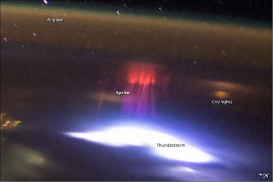 Figure 11: Two minutes and 58 seconds later, as the ISS was over the coastal Mexican resort of Acapulco, the crew documented another red sprite over a brilliant white thundercloud and lightning discharge near the coast of El Salvador. The shorter distance to the storm—about 1,150 km—makes it somewhat easier to see details of the sprite. City lights are a diffuse yellow because they are shining through clouds (image credit: NASA/JSC)
