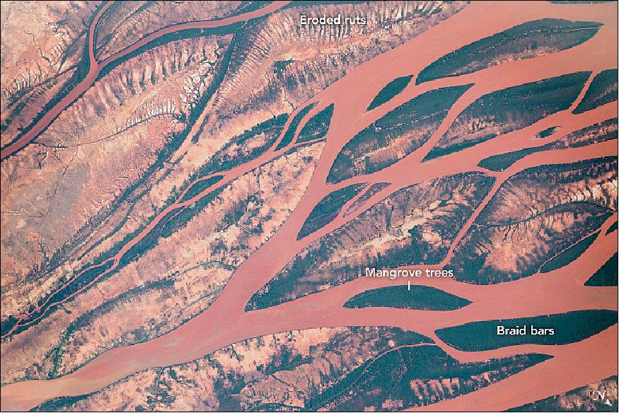 Figure 23: The braided river carries iron-rich sediment from the high central plateau and mountains down through complex, woven channels and vegetated islands. The astronaut photograph ISS056-E-62768 was acquired on June 29, 2018, with a Nikon D5 digital camera using an 800 mm lens and is provided by the ISS Crew Earth Observations Facility and the Earth Science and Remote Sensing Unit, Johnson Space Center. The image was taken by a member of the Expedition 56 crew. (image credit: NASA/JSC, caption by Andrea Meado)