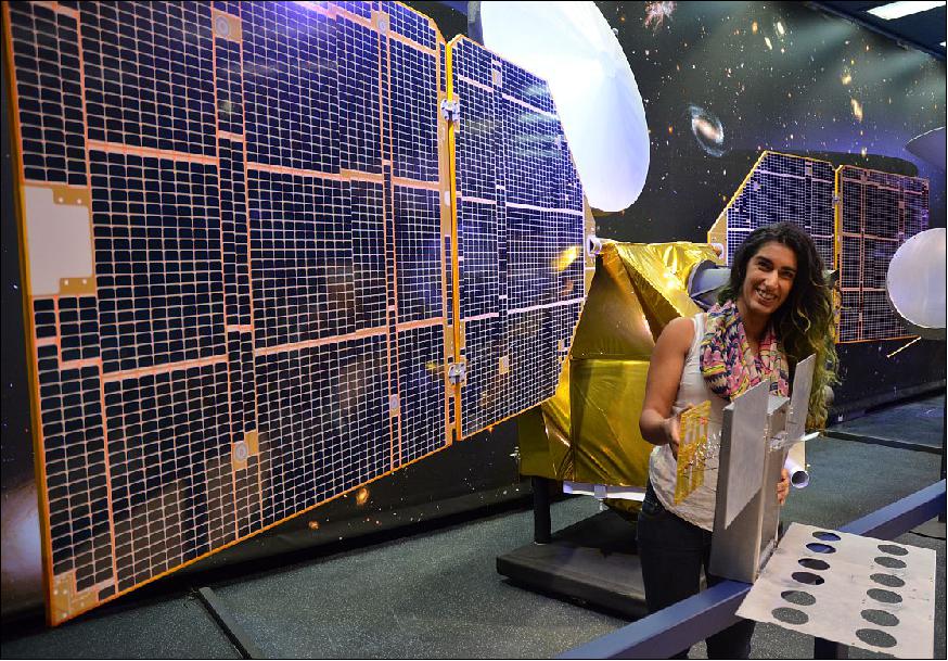 Figure 6: The full-scale mock-up of NASA's MarCO CubeSat held by Farah Alibay, a systems engineer for the technology demonstration, is dwarfed by the one-half-scale model of NASA's Mars Reconnaissance Orbiter behind her (image credit: NASA/JPL)