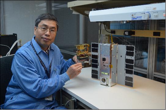 Figure 21: IceCube Principal Investigator Dong Wu set out to demonstrate a commercial 883 GHz radiometer in space, but ended up getting much more: the world's first ice-cloud map in that frequency. Here he is pictured holding the instrument (image credit: NASA)