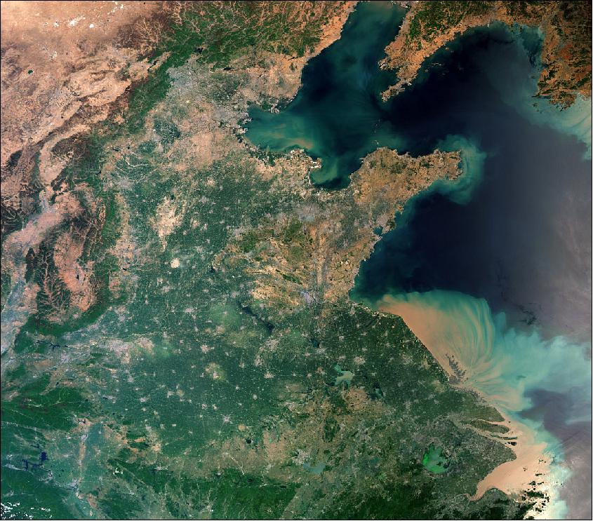 Figure 11: This true color image taken using Sentinel-3A's OLCI (Ocean and Land Color Instrument) shows the huge amount of sediment carried into the ocean along the coast. The image covers an area of over 1200 km side length, showing Beijing at the center-top, the salt flats close to the Mongolian border in the top left, and North Korea, with its capital, Pyongyang, just visible in the top right of the image. A large number of urban settlements represented as grey flecks are interspersed with agricultural fields, dominating the central part of the image (image credit: ESA, the image contains modified Copernicus Sentinel data (2017), processed by ESA, CC BY-SA 3.0 IGO)