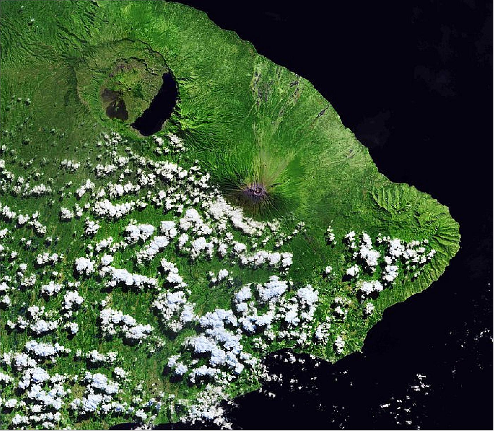Figure 27: Dotted with clouds, Mount Seraya is visible on the peninsula that juts to the east. Its volcanic rock creates a rugged terrain, but is surrounded by lush vegetation. The area is well known for its many Hindu temples, including the famous Lempuyang Temple, known locally as Pura Luhur Lempuyang. This image of Sentinel-2, captured on 2 July 2018, is also featured on the Earth from Space video program (image credit: ESA, the image contains modified Copernicus Sentinel data (2018), processed by ESA, CC BY-SA 3.0 IGO)
