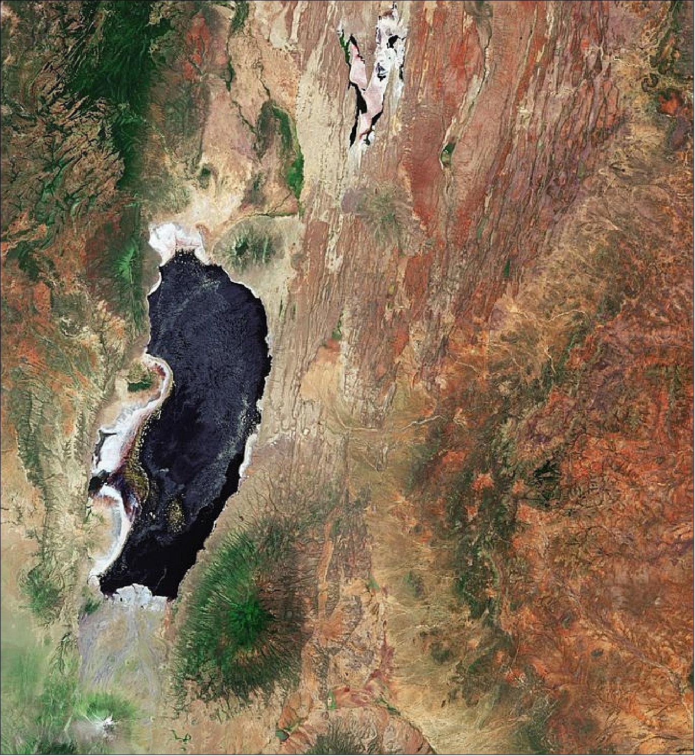 Figure 10: Lake Natron is around 60 km long and is fed mainly by the Ewaso Ng'iro River. Despite its dark color in this image, Lake Natron is often bright red owing to the presence of microorganisms that feed on the salts of the water. Sentinel-2 acquired this image on 3 February 2019, it is also featured on the Earth from Space video program (image credit: ESA, the image contains modified Copernicus Sentinel data (2019), processed by ESA, CC BY-SA 3.0 IGO)