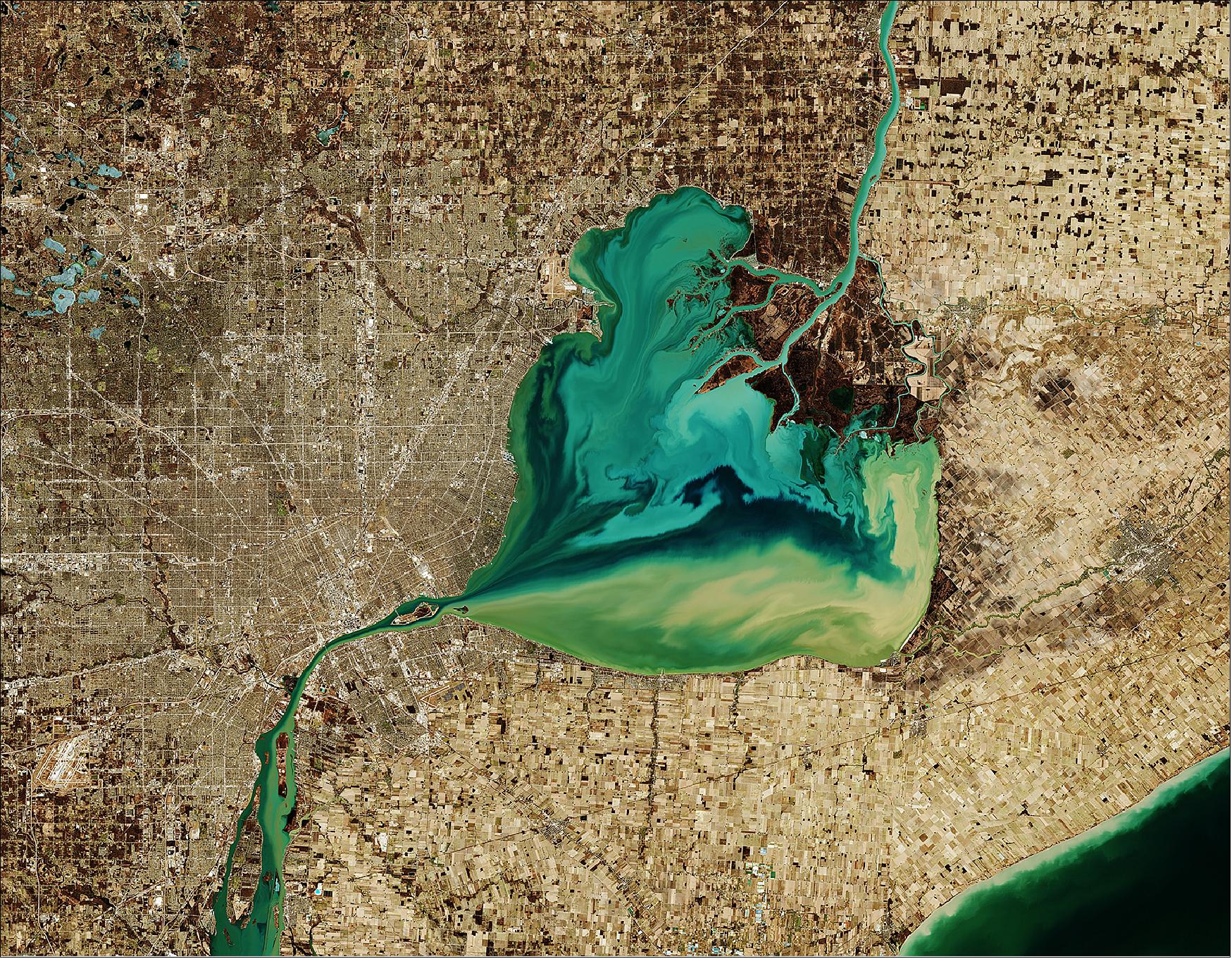 Figure 3: The Saint Clair River is visible at the top of the image and flows southwards, connecting the southern end of Lake Huron with Lake St. Clair, visible in the center of the image. The river branches into several channels before reaching the lake, creating a seven-mouth delta. Much of the area surrounding the delta is used for agriculture. In this wintery image, captured on 26 March 2019, many of the frozen lakes northwest of the lake can be seen partially frozen over. The Copernicus Sentinel-2 mission allows inland bodies of water to be closely monitored. This image is also featured on the Earth from Space video program (image credit: ESA, the image contains modified Copernicus Sentinel data (2019), processed by ESA, CC BY-SA 3.0 IGO)