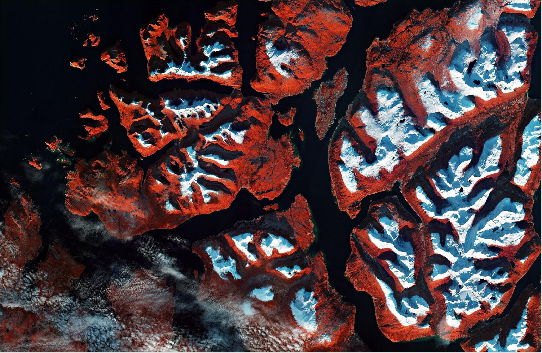 Figure 1: This false-color image was processed in a way that included the near-infrared channel, which makes vegetation appear bright red. The snow over the surrounding mountains is visible in white, adding to the Christmas feel of the image. This image is also featured on the Earth from Space video program (image credit: ESA, the image contains modified Copernicus Sentinel data (2019), processed by ESA, CC BY-SA 3.0 IGO)