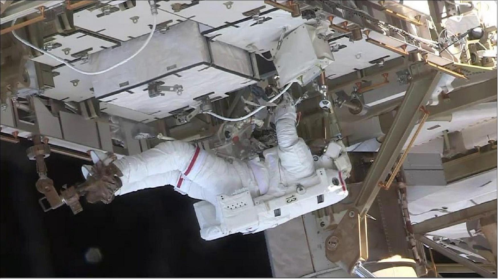 Figure 102: Spacewalker Nick Hague works to upgrade the International Space Station‘s power storage capacity during today’s six hour and 45-minute spacewalk (image credit: NASA TV)