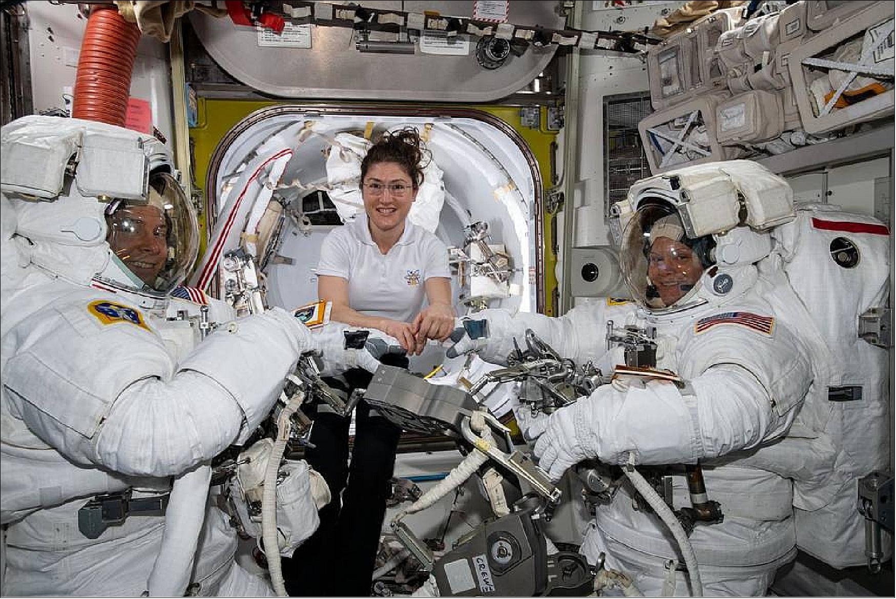 Figure 101: NASA astronaut Christina Koch, in the center of the image, assists fellow astronauts Nick Hague and Anne McClain in their spacesuits shortly before they begin the first spacewalk of their careers. Hague and McClain worked outside, in the vacuum of space, for six hours and 39 minutes on March 22, 2019, to upgrade the International Space Station's power storage capacity (image credit: NASA) 83)