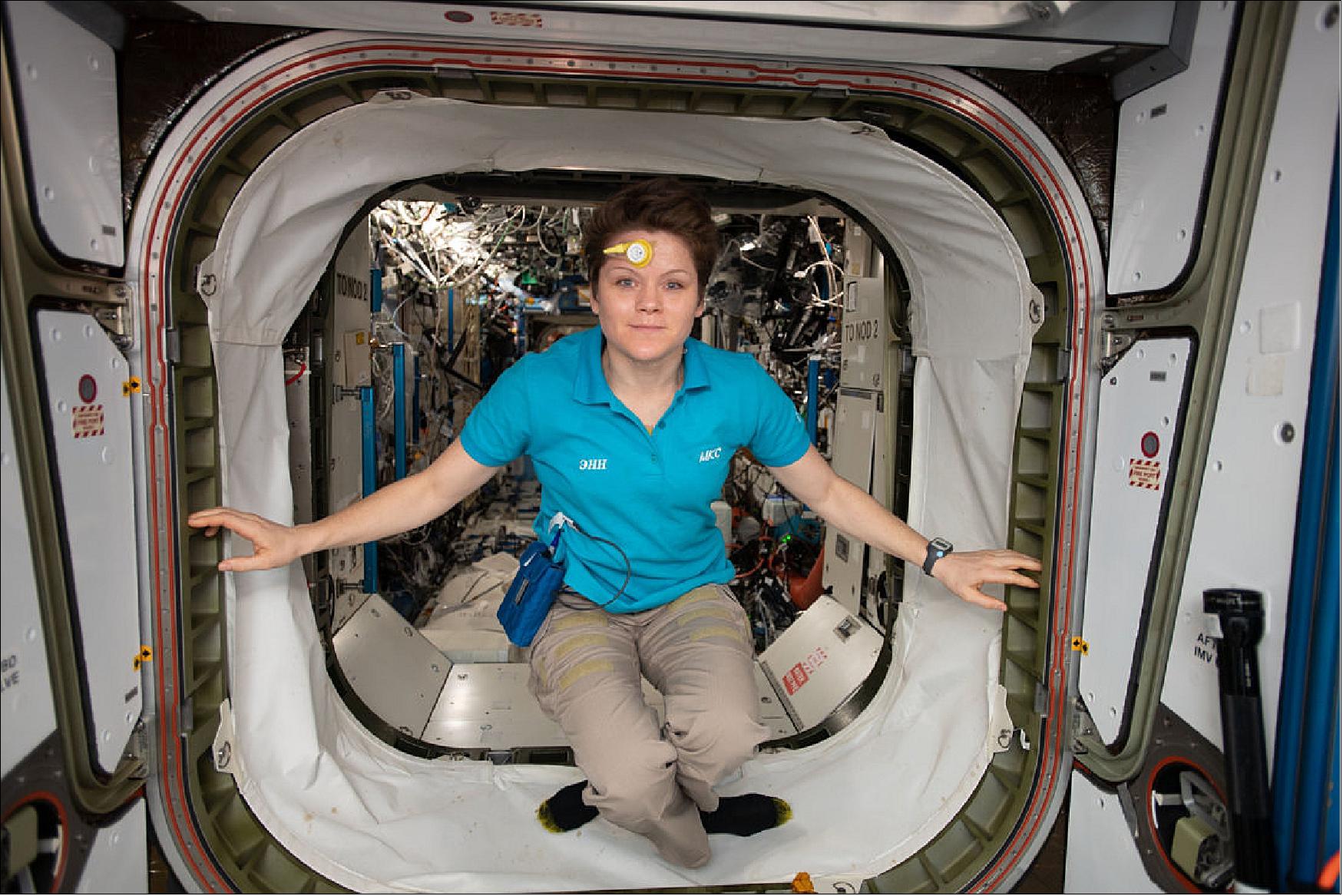 Figure 118: NASA astronaut and Expedition 58 flight engineer Anne McClain pictured inside the vestibule between the Harmony module and the Destiny laboratory module. She is wearing a sensor on her forehead that is collecting data for the Circadian Rhythms experiment researching how an astronaut's “biological clock” changes during long-duration spaceflight (image credit: NASA)