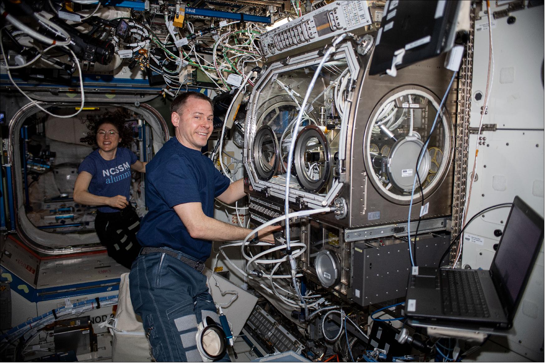 Figure 45: NASA astronaut Nick Hague works on the Ring Sheared Drop investigation in the Microgravity Sciences Glovebox as NASA astronaut Christina Koch observes. Ring Sheared Drop examines the formation and flow of amyloids in microgravity (image credit: NASA)