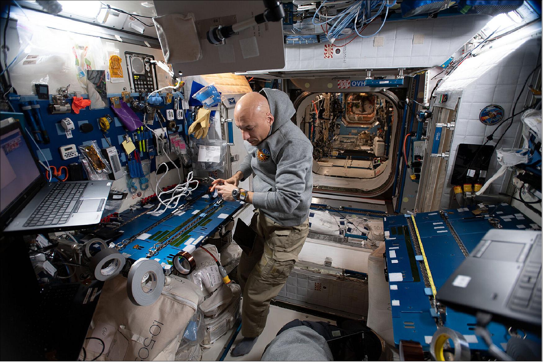 Figure 25: Luca is preparing for his EVA (Extra Vehicular Activity) on 15 November. He is pictured here creating tape flags that will be used to mark tubes during the spacewalks (image credit: ESA/NASA)