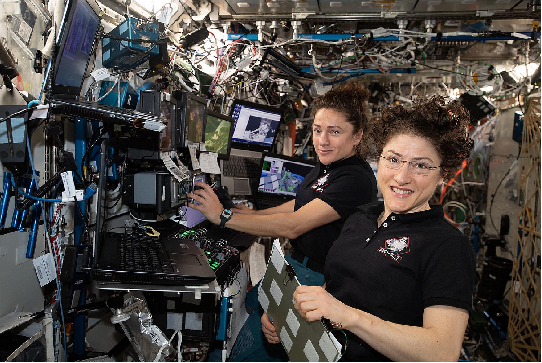 Figure 20: NASA astronauts (from left ) Jessica Meir and Christina Koch are at the robotics workstation controlling the Canadarm2 robotic arm to support the first spacewalk to repair the Alpha Magnetic Spectrometer (AMS). Astronauts Luca Parmitano of ESA (European Space Agency) and Andrew Morgan of NASA worked six hours and 39 minutes in the vacuum of space during the first of at least four planned AMS repair spacewalks (image credit: NASA) 15)