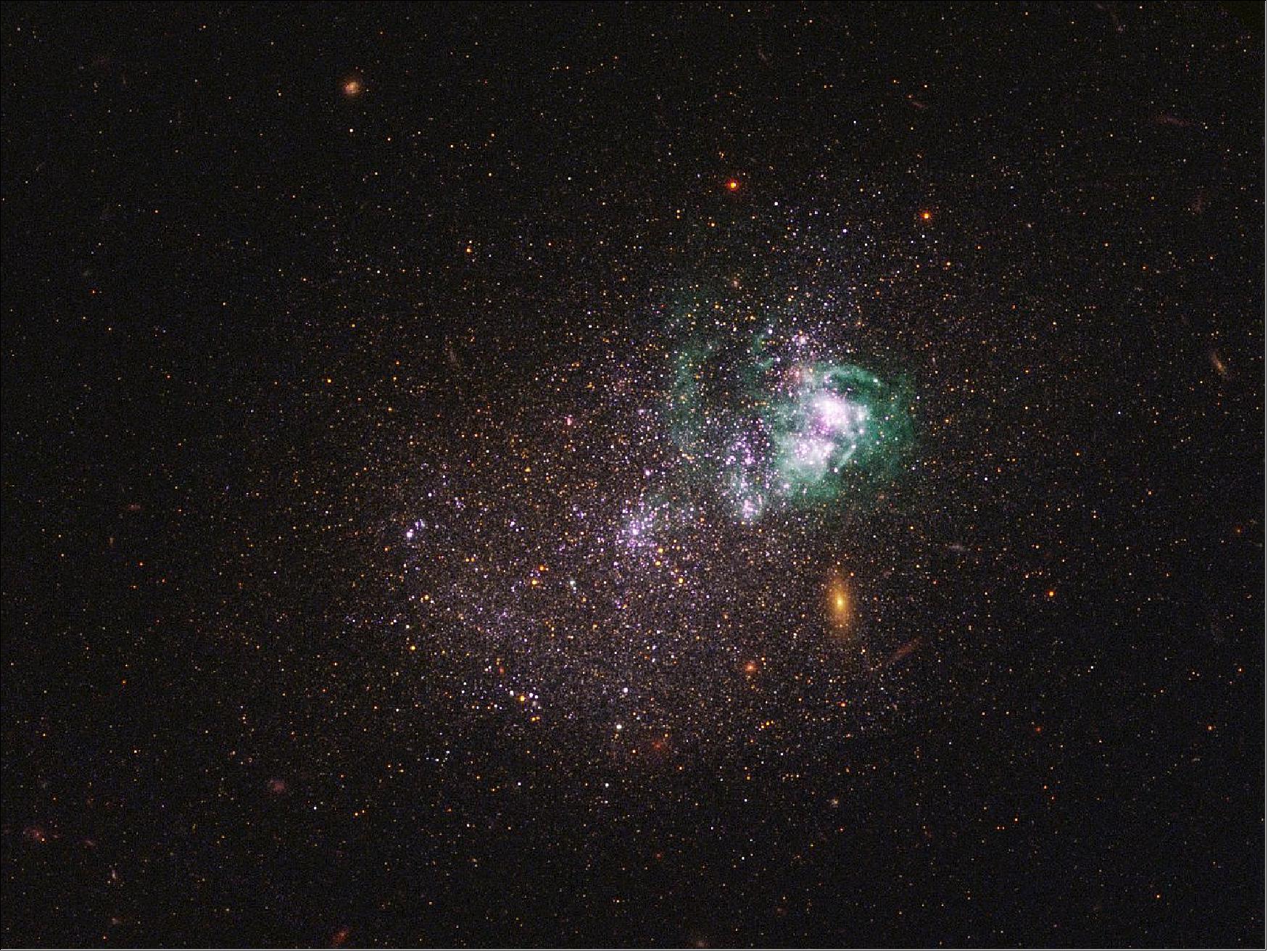 Figure 37: Dwarf galaxy UGCA 281. UGCA 281 is a blue compact dwarf galaxy located in the constellation of Canes Venatici. Within it, two giant star clusters appear brilliant white and are swaddled by greenish hydrogen gas clouds. These clusters are responsible for most of the recent star formation in UGCA 281; the rest of the galaxy is comprised of older stars and appears redder in color. The reddish objects in the background are background galaxies that appear through the diffuse dwarf galaxy. The image is a composite using both ultraviolet light and visible light, gathered with Hubble's Wide Field Camera 3 and Advanced Camera for Surveys (image credit: NASA, ESA, and the LEGUS team)