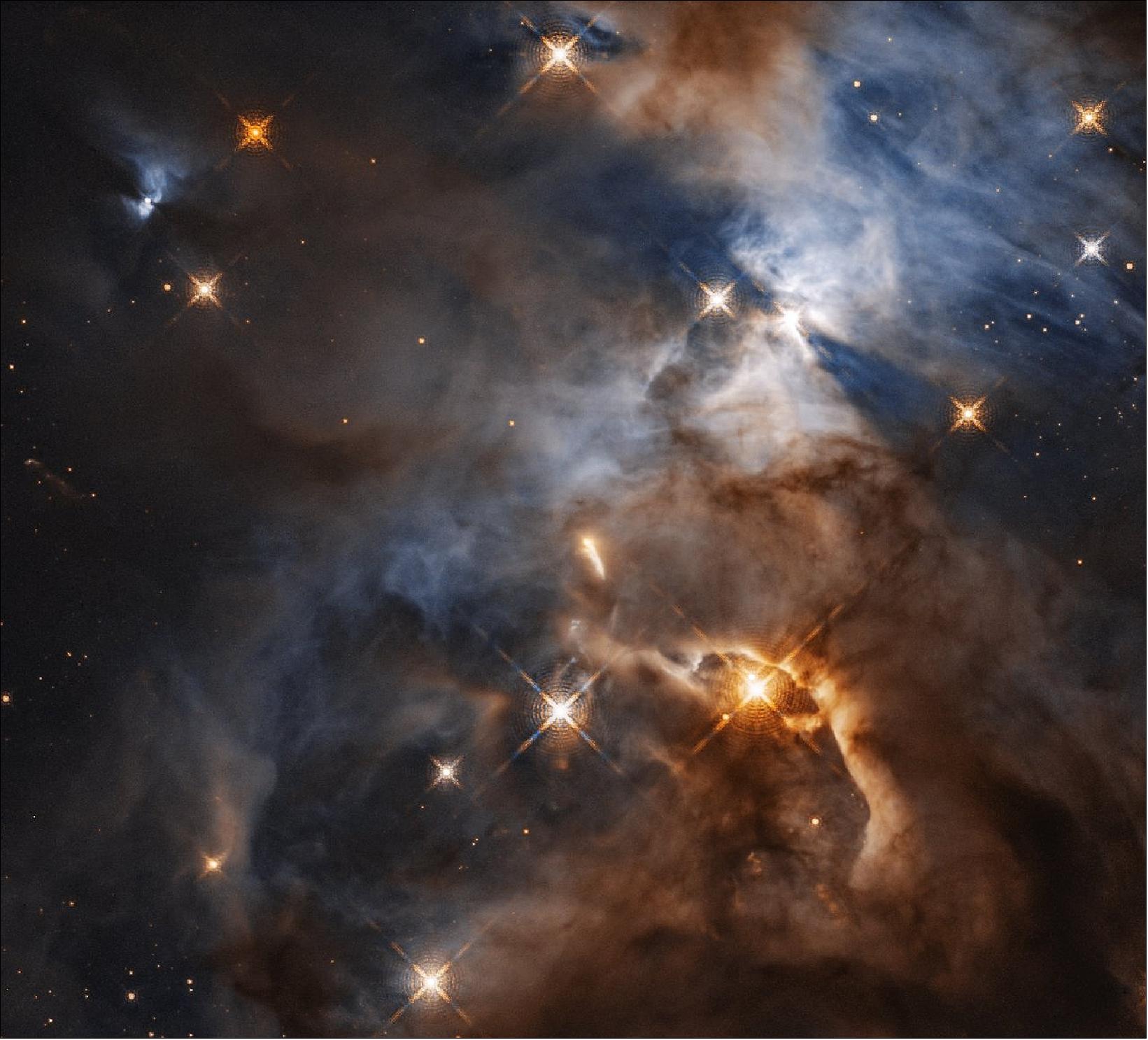 Figure 11: This image, taken with the NASA/ESA Hubble Space Telescope shows the Serpens Nebula, a stellar nursery about 1300 light-years away. Within the nebula, in the upper right of the image, a shadow is created by the protoplanetary disc surrounding the star HBC 672. While the disc of debris is too tiny to be seen even by Hubble, its shadow is projected upon the cloud in which it was born. In this view, the feature – nicknamed the Bat Shadow – spans approximately 200 times the diameter of our own Solar System. - A similar looking shadow phenomenon can be seen emanating from another young star, in the upper left of the image (image credit: NASA, ESA, and STScI, CC BY 4.0)