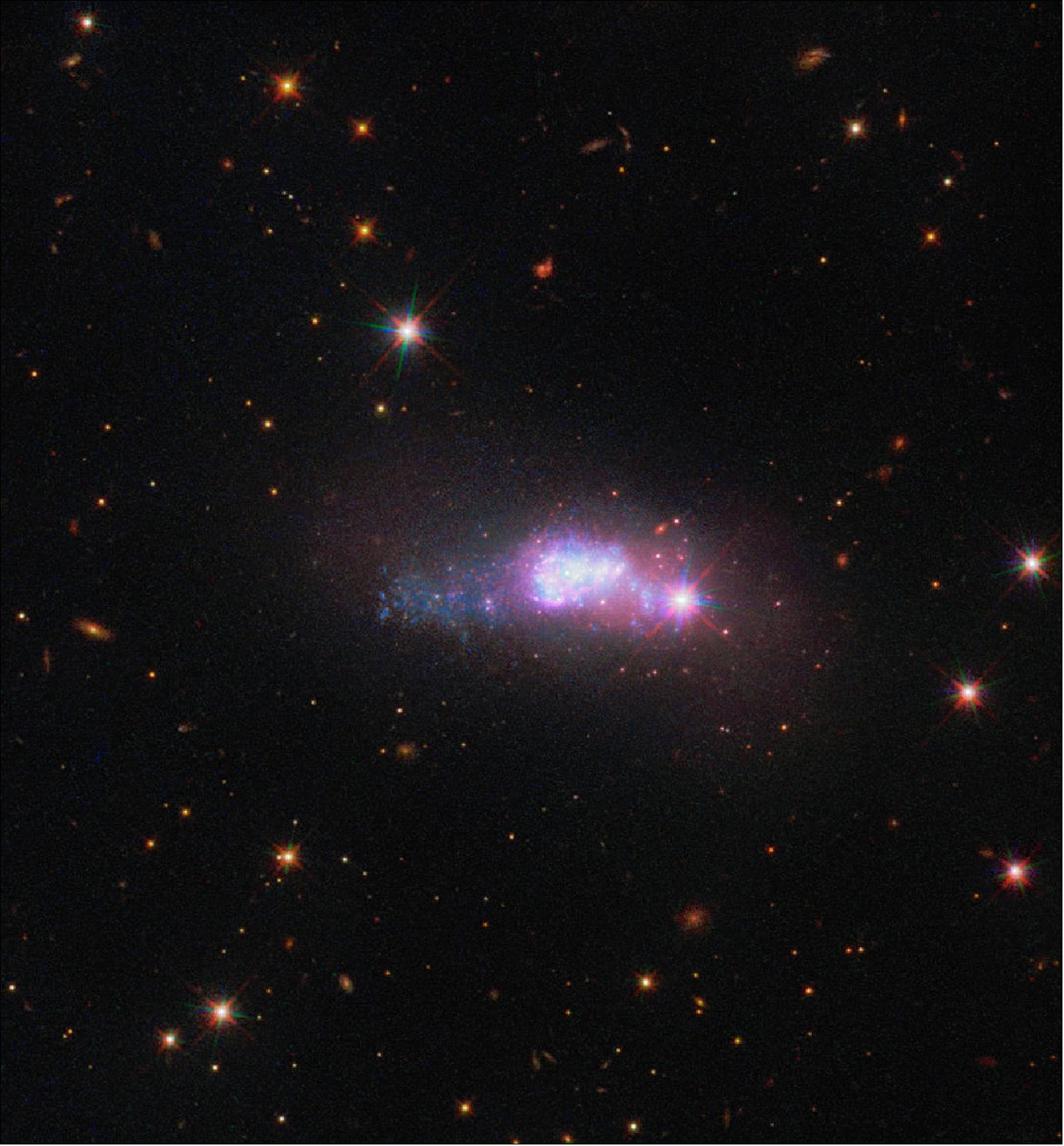 Figure 9: This captivating image from the NASA/ESA Hubble Space Telescope’s Wide Field Camera 3 shows a lonely dwarf galaxy, a staggering 100 million light-years away from Earth. This image depicts the blue compact dwarf galaxy ESO 338-4, which can be found in the constellation of Corona Australis (the Southern Crown), image credit: ESA/Hubble & NASA