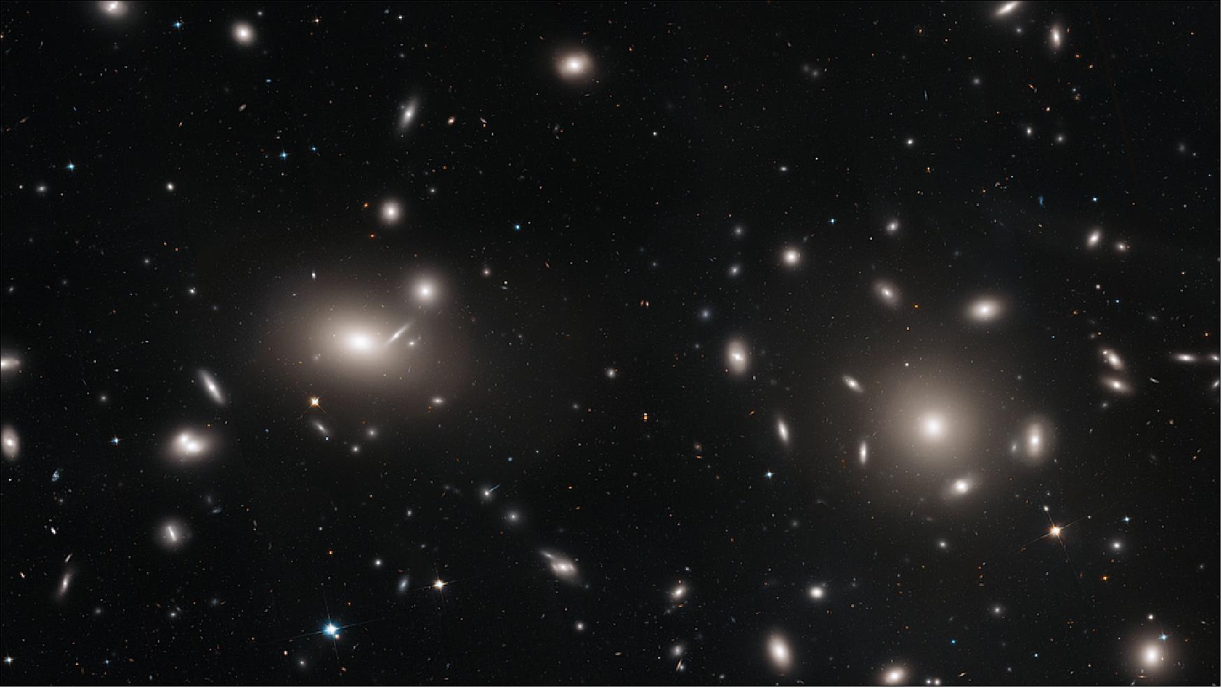 Figure 5: This is a Hubble Space Telescope mosaic of a portion of the immense Coma cluster of over 1,000 galaxies, located 300 million light-years from Earth. Hubble's incredible sharpness was used to do a comprehensive census of the cluster's most diminutive members: a whopping 22,426 globular star clusters. Among the earliest homesteaders of the universe, globular star clusters are snow-globe-shaped islands of several hundred thousand ancient stars. The survey found the globular clusters scattered in the space between the galaxies. They have been orphaned from their home galaxies through galaxy tidal interactions within the bustling cluster. Astronomers will use the globular cluster field for mapping the distribution of matter and dark matter in the Coma galaxy cluster [image credit: NASA, ESA, J. Mack (STScI) and J. Madrid (Australian Telescope National Facility)]