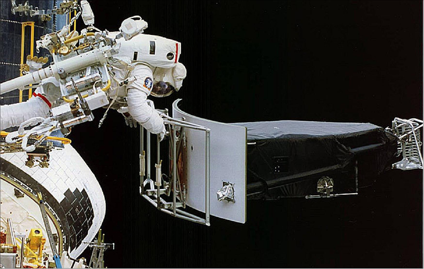 Figure 4: Replacing the Wide Field and Planetary Camera. Astronaut Jeffrey Hoffman removes Wide Field and Planetary Camera 1 (WFPC 1) during change-out operations (image credit: NASA)