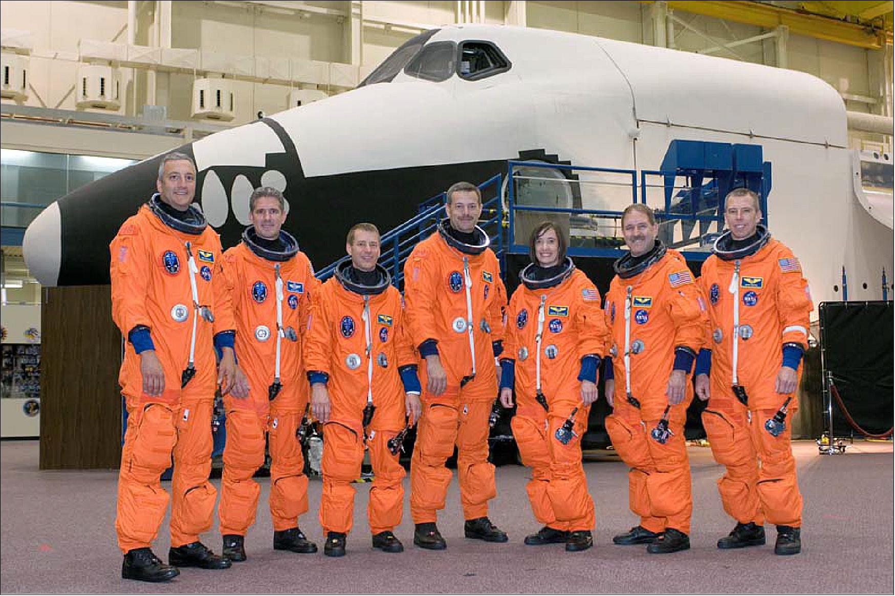 Figure 62: The STS‐125 crew members take a moment to pose for a crew photo before a training session in the Space Vehicle Mockup Facility at NASA’s Johnson Space Center. From the left are astronauts Mike Massimino, Michael Good, both mission specialists; Gregory C. Johnson, pilot; Scott Altman, commander; Megan McArthur, John Grunsfeld and Andrew Feustel, all mission specialists (image credit: NASA)