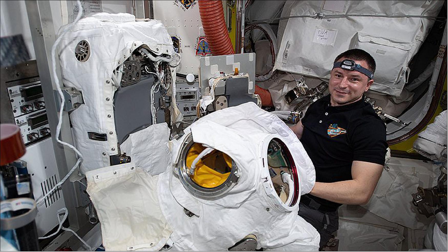 Figure 4: Expedition 62 Flight Engineer Andrew Morgan works on U.S. spacesuit components inside the Quest airlock (image credit: NASA)