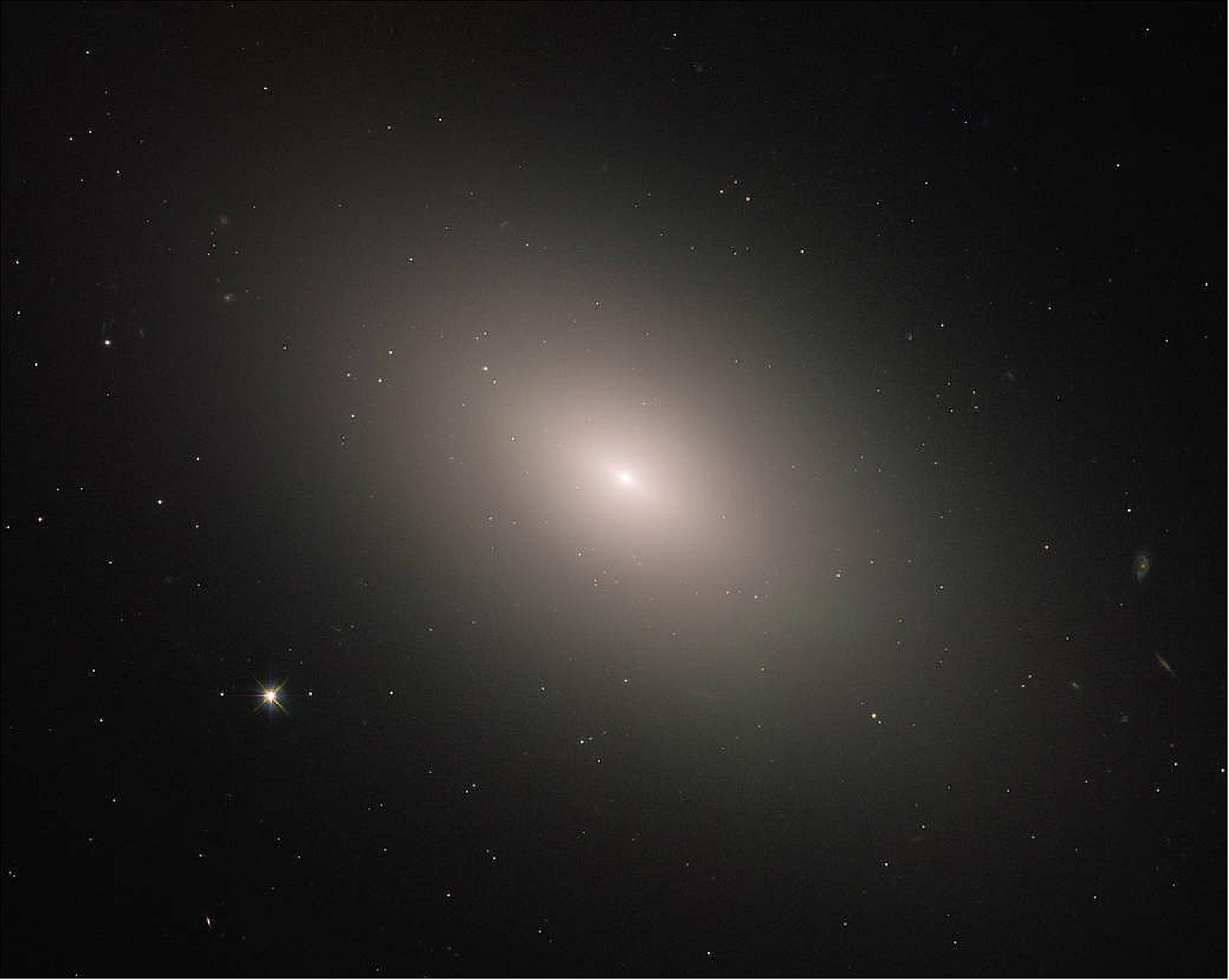 Figure 47: Modern observations show that Messier 59 is an elliptical galaxy, one of the three main kinds of galaxies along with spirals and irregulars. Ellipticals tend to be the most evolved of the trio, full of old, red stars and exhibiting little or no new star formation. Messier 59, however, bucks this trend somewhat; the galaxy does show signs of star formation, with some newborn stars residing within a disk near the core (image credit: ESA/Hubble & NASA, P. Cote)