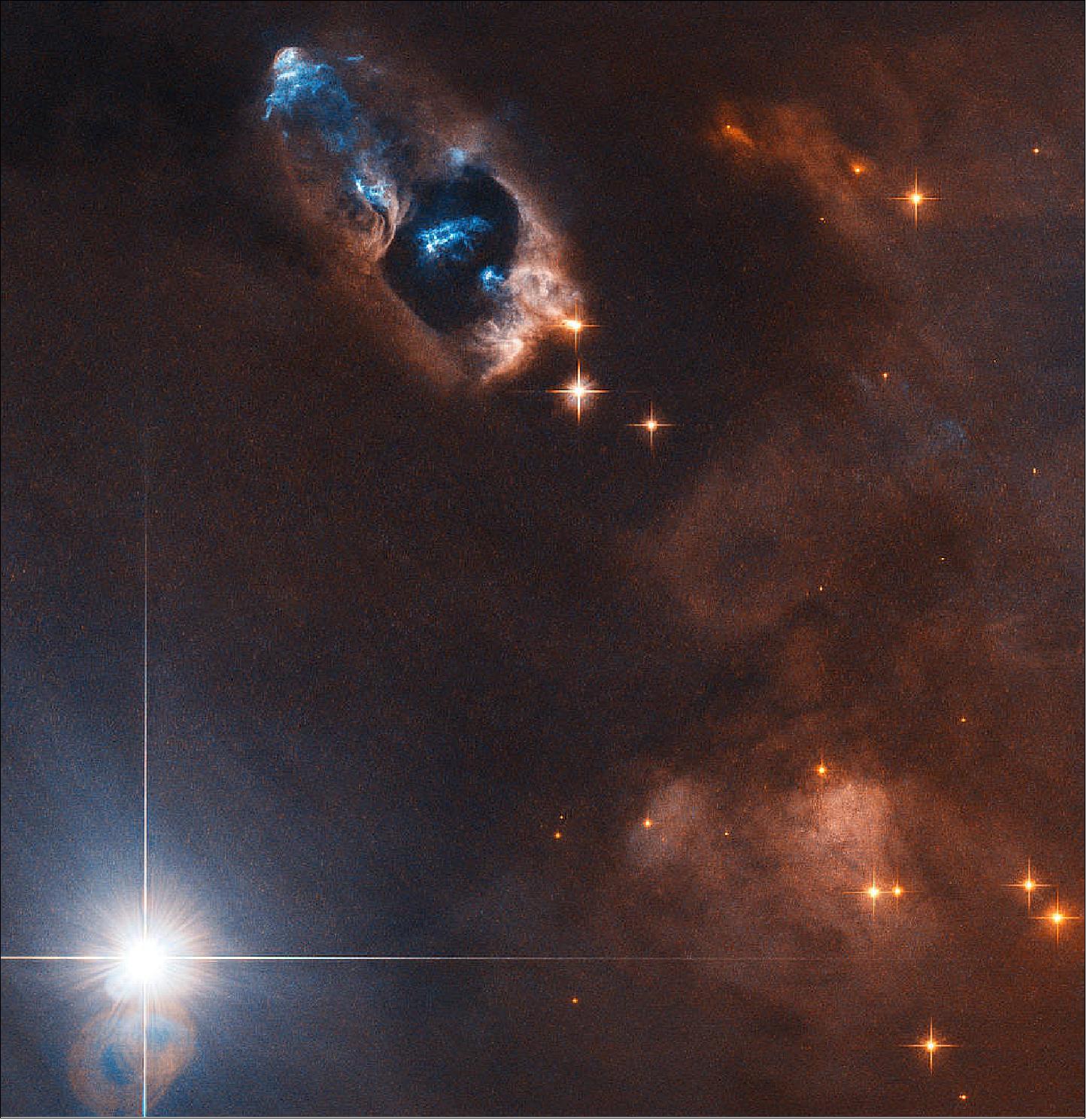 Figure 71: In this image, the NASA/ESA Hubble Space Telescope has captured the smoking gun of a newborn star, the Herbig–Haro objects numbered 7 to 11 (HH 7–11). These five objects, visible in blue in the top center of the image, lie within NGC 1333, a reflection nebula full of gas and dust found about a thousand light-years away from Earth (image credit: ESA/Hubble & NASA, K. Stapelfeldt)