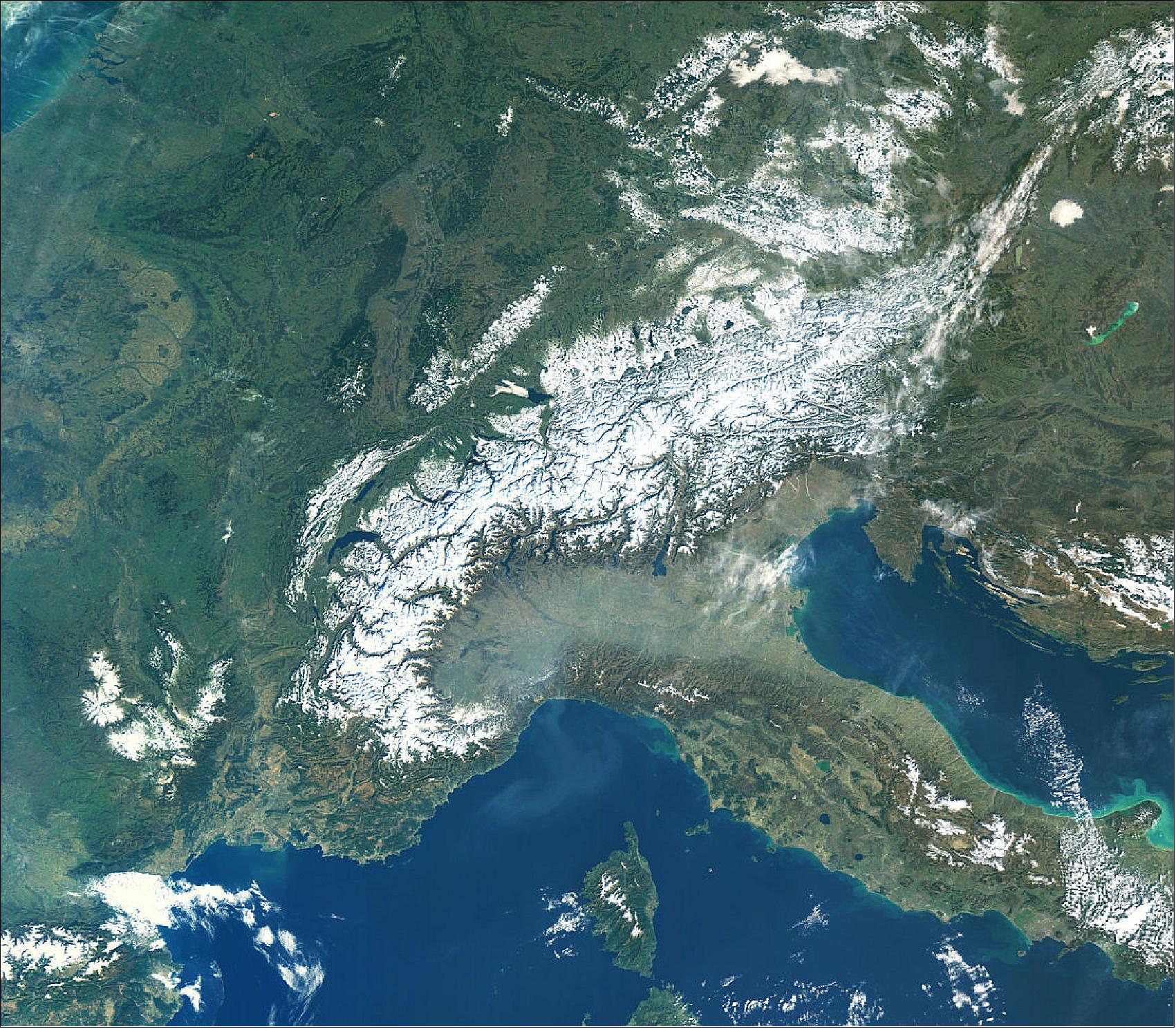 Figure 21: Captured on 16 February 2019 with Sentinel-3A, this true-color image shows little clouds, particularly over the Alps and the surrounding flatter lands in southern France. There is an interesting contrast between this and the haze hanging over the Po valley in Italy, directly south of the Alps. The haze is most likely to be a mix of both fog and smog, trapped at the base of the Alps owing to both its topography and atmospheric conditions. This image is also featured on the Earth from Space video program (image credit: ESA, the image contains modified Copernicus Sentinel data (2018), processed by ESA, CC BY-SA 3.0 IGO)