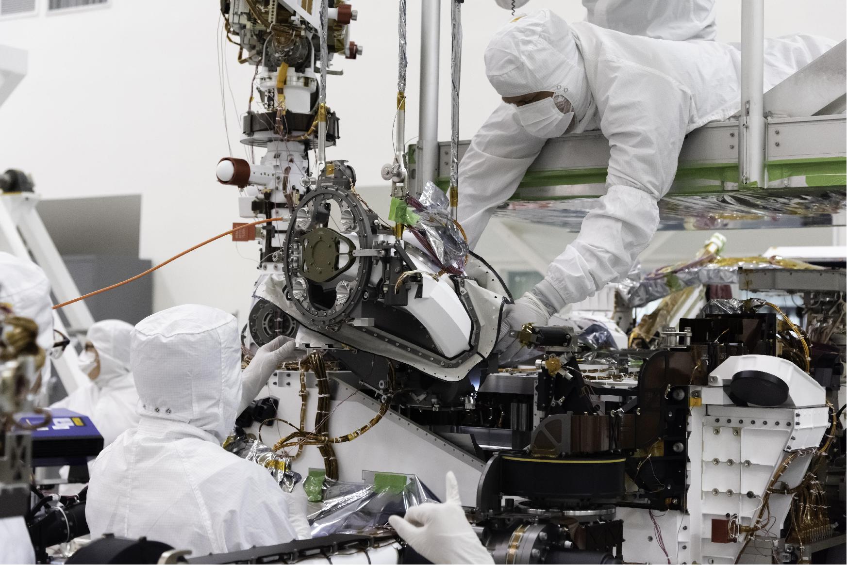 Figure 16: The bit carousel, which lies at the heart of Sample Caching System of NASA's Mars 2020 mission, is attached to the front end of the rover in the Spacecraft Assembly Facility's High Bay 1 at the Jet Propulsion Laboratory in Pasadena, California. The carousel contains all of the tools the coring drill uses to sample the Martian surface and is the gateway for the samples to move into the rover for assessment and processing (image credit: NASA/JPL-Caltech)