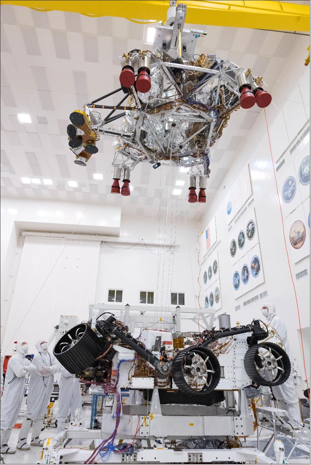 Figure 11: In this picture from Sept. 28, 2019, engineers and technicians working on the Mars 2020 spacecraft at NASA's Jet Propulsion Laboratory in Pasadena, California, look on as a crane lifts the rocket-powered descent stage away from the rover after a test (image credit: NASA/JPL-Caltech)